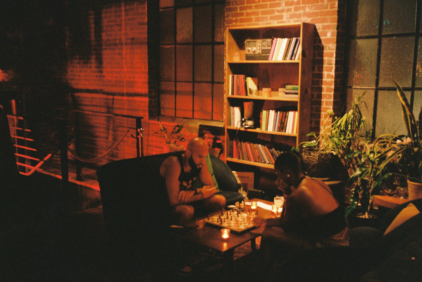 The bar at Margolis mid-evening, bottles lit from behind