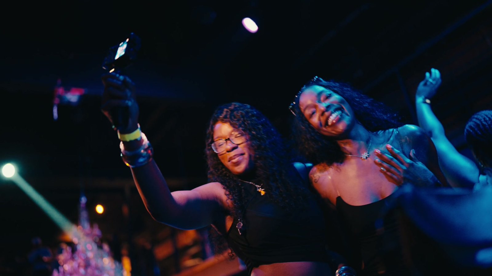 Two guests laughing into a phone camera on the dance floor at Fabrika