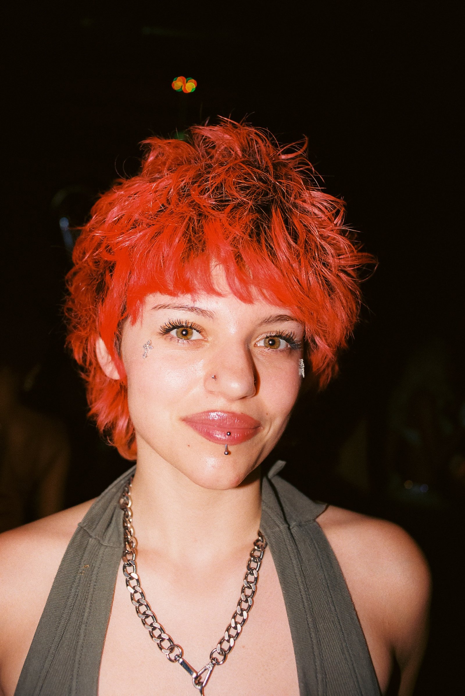 Guest with cropped red hair and a chain necklace at Margolis in Fishtown