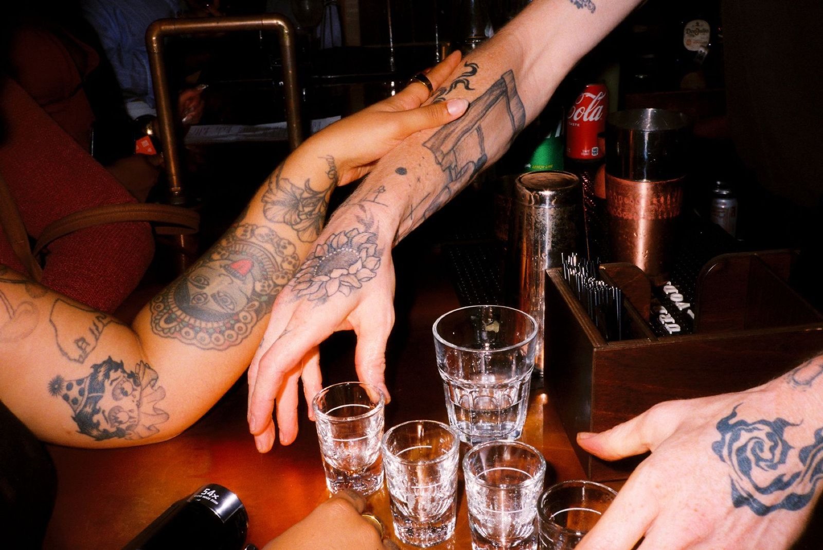 Hands reaching across the bar for a round of shots at Margolis